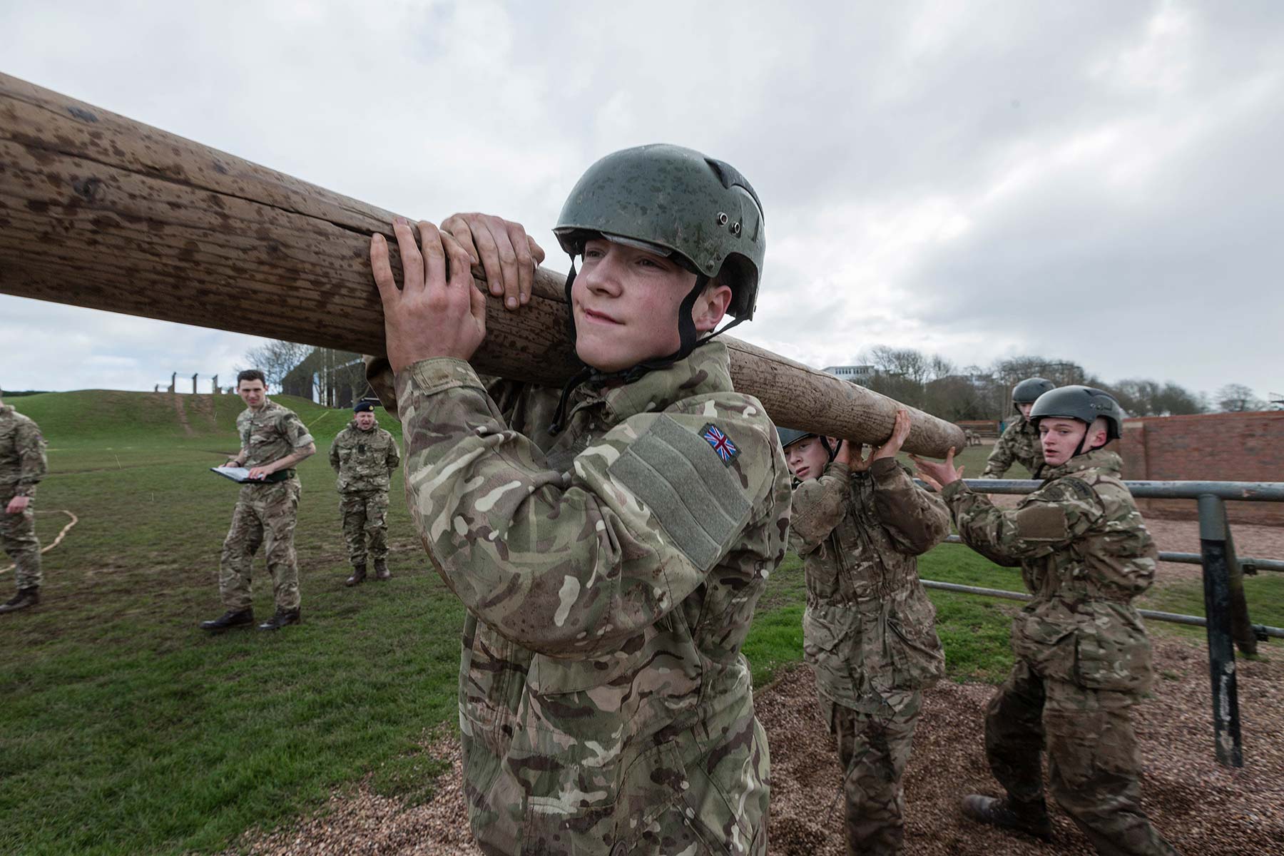 Royal Marine cadets working as a team to carry a log